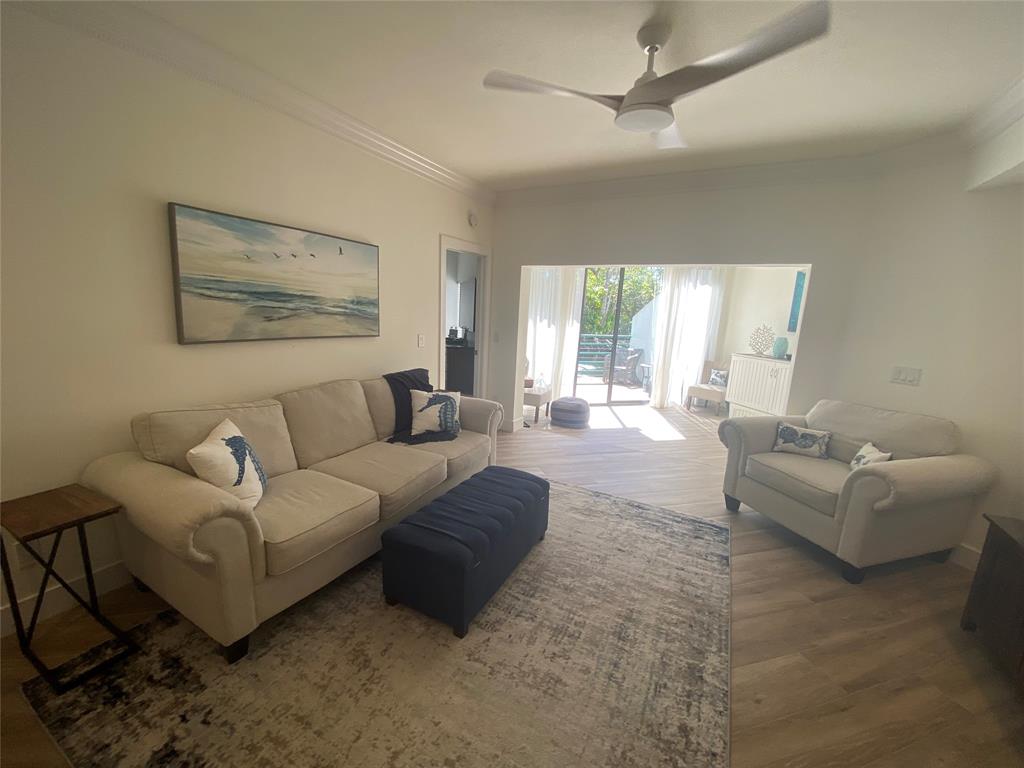 2286 Anchorage Lane, Unit A Naples, FL 34104 - Photo 10 of 41 a living room with furniture and a large window
