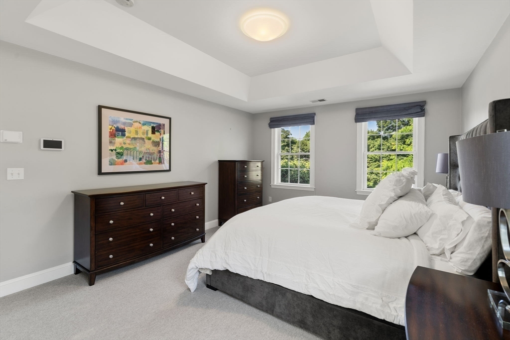 1 Austin Way Natick, MA 01760 - Photo 18 of 27 a bedroom with a bed and a dresser next to a window