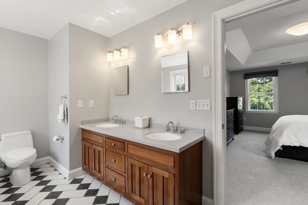 1 Austin Way Natick, MA 01760 - Photo 21 of 27 a spacious bathroom with a double vanity sink a mirror and a toilet