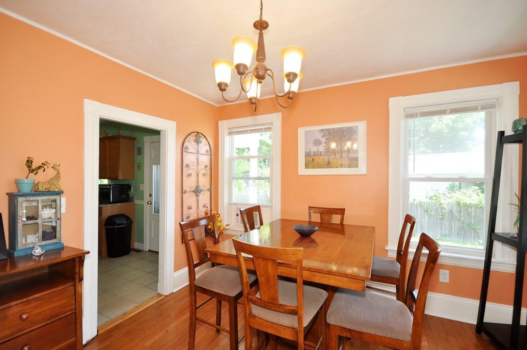 28 Ayer Road Shirley, MA 01464 - Photo 7 of 20 a dining room with wooden floor a chandelier a wooden table and chairs