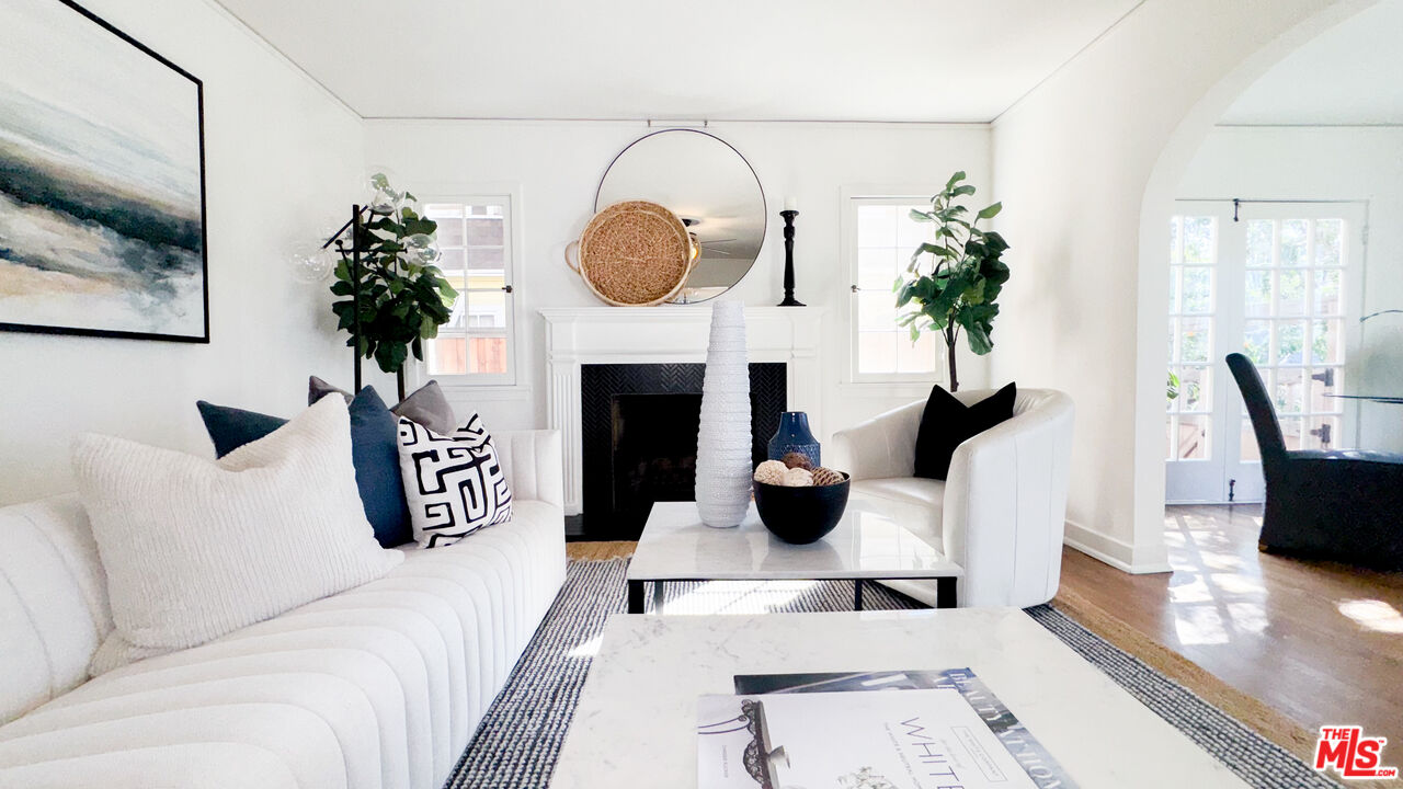 13529 Beverly Boulevard Whittier, CA 90601 - Photo 12 of 54 a living room with furniture a potted plant and a fireplace