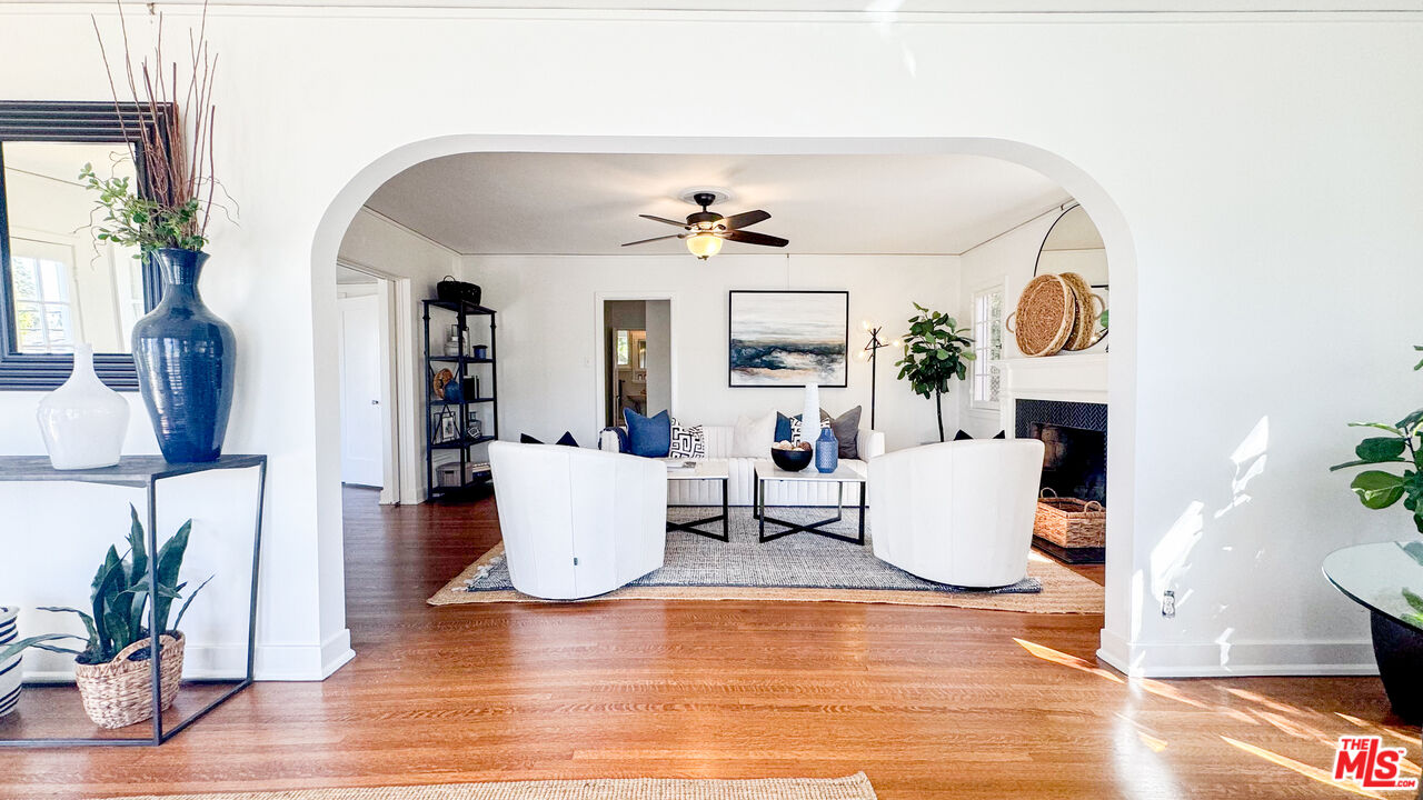 13529 Beverly Boulevard Whittier, CA 90601 - Photo 13 of 54 a living room with fireplace furniture and a wooden floor