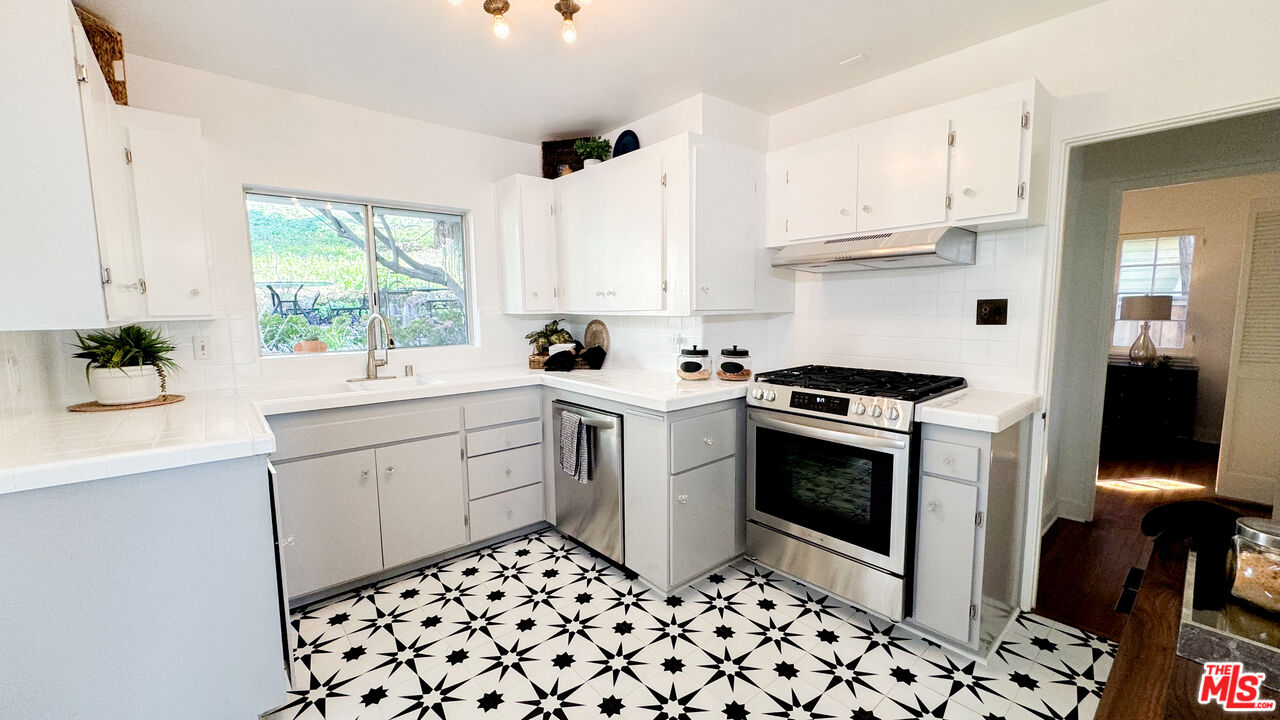 13529 Beverly Boulevard Whittier, CA 90601 - Photo 16 of 54 a kitchen with a sink cabinets and window