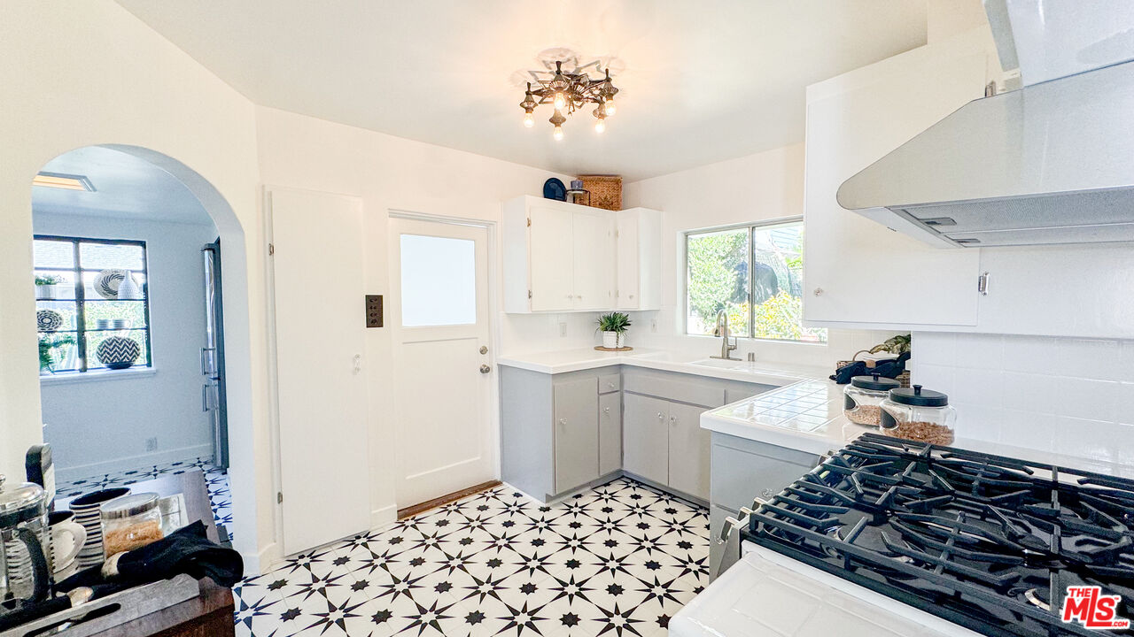 13529 Beverly Boulevard Whittier, CA 90601 - Photo 21 of 54 a kitchen with a sink and a stove top oven