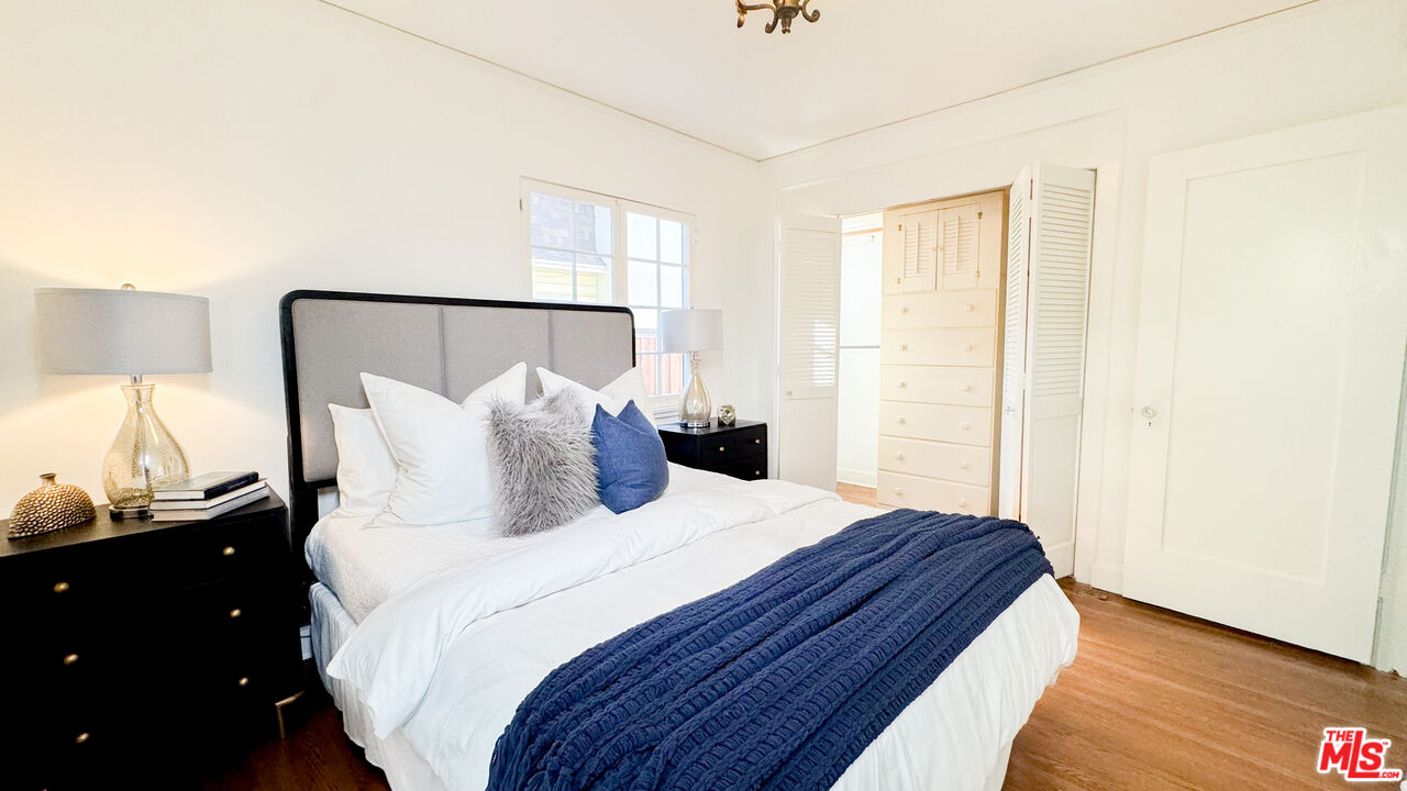 13529 Beverly Boulevard Whittier, CA 90601 - Photo 27 of 54 a bedroom with a bed and a night stand