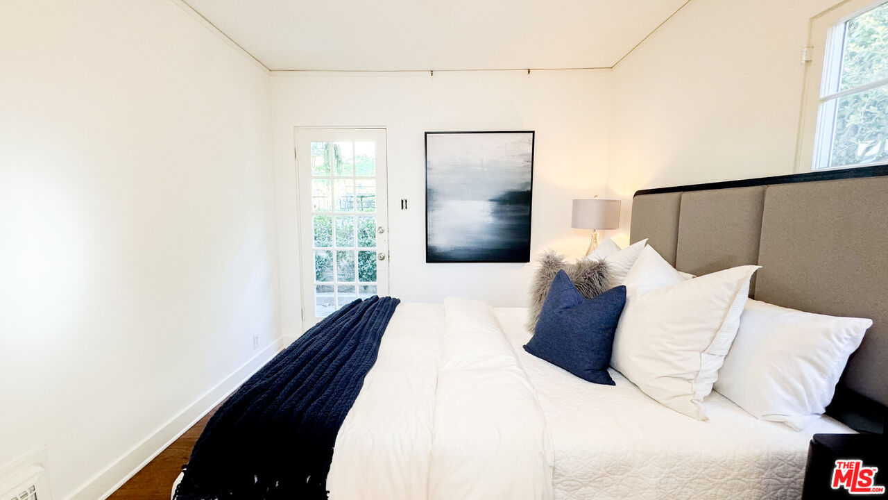 13529 Beverly Boulevard Whittier, CA 90601 - Photo 28 of 54 a bedroom with a bed and a potted plant