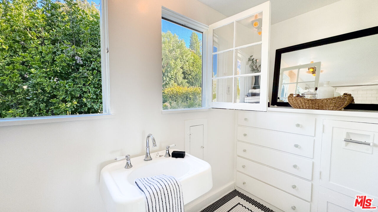 13529 Beverly Boulevard Whittier, CA 90601 - Photo 36 of 54 a bathroom with a sink and a mirror