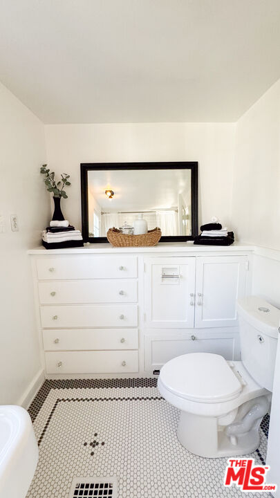13529 Beverly Boulevard Whittier, CA 90601 - Photo 41 of 54 a bathroom with a toilet a sink and mirror