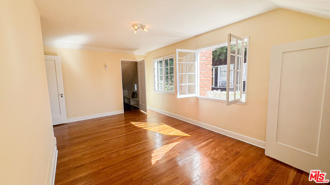 13529 Beverly Boulevard Whittier, CA 90601 - Photo 42 of 54 a view of an empty room with wooden floor and a window