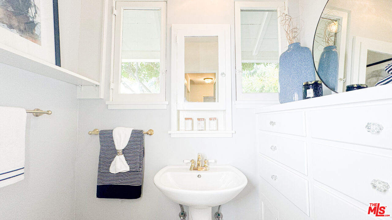 13529 Beverly Boulevard Whittier, CA 90601 - Photo 46 of 54 a bathroom with a sink and a mirror