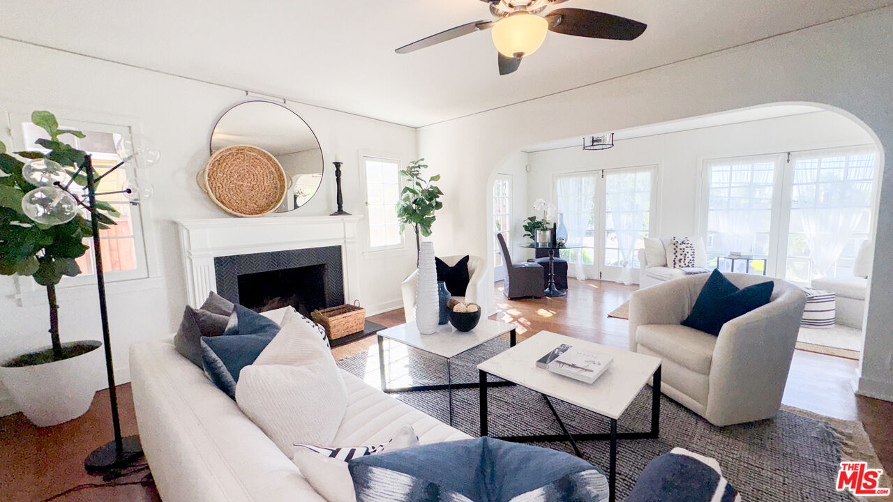 13529 Beverly Boulevard Whittier, CA 90601 - Photo 6 of 54 a living room with furniture a fireplace and a potted plant
