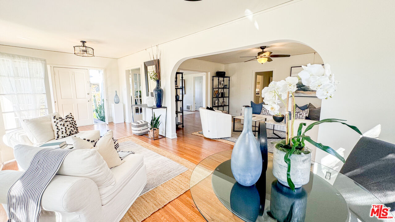 13529 Beverly Boulevard Whittier, CA 90601 - Photo 8 of 54 a living room with furniture flowers and a chandelier
