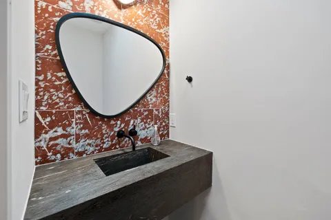 a bedroom with a large bed and a painting on the wall