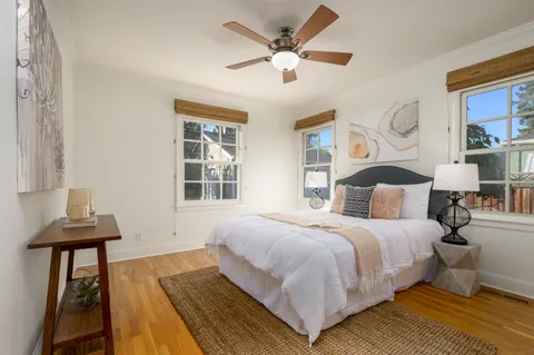 a bedroom with a bed and wooden floor
