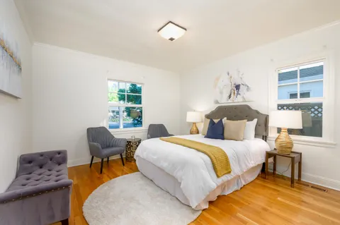 a bedroom with a bed and wooden floor