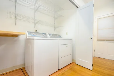 a utility room with cabinets washer and dryer
