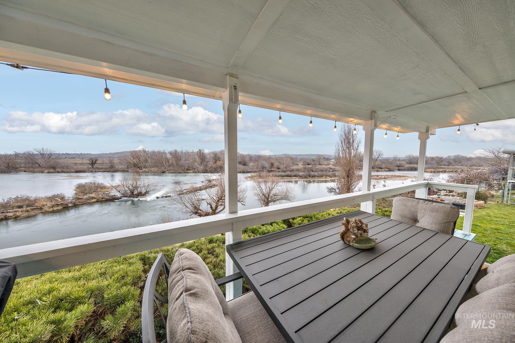 Deck featuring outdoor dining area and a water view