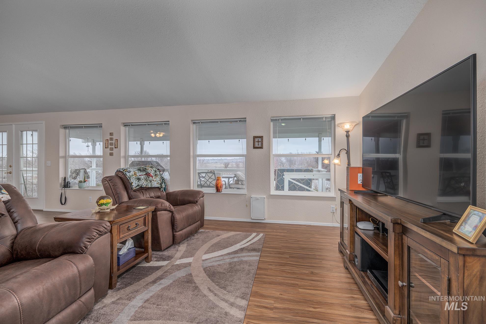 2750 Alden Road, Unit 27 Fruitland, ID 83619 - Photo 12 of 45 Living room featuring light wood-type flooring and a textured ceiling