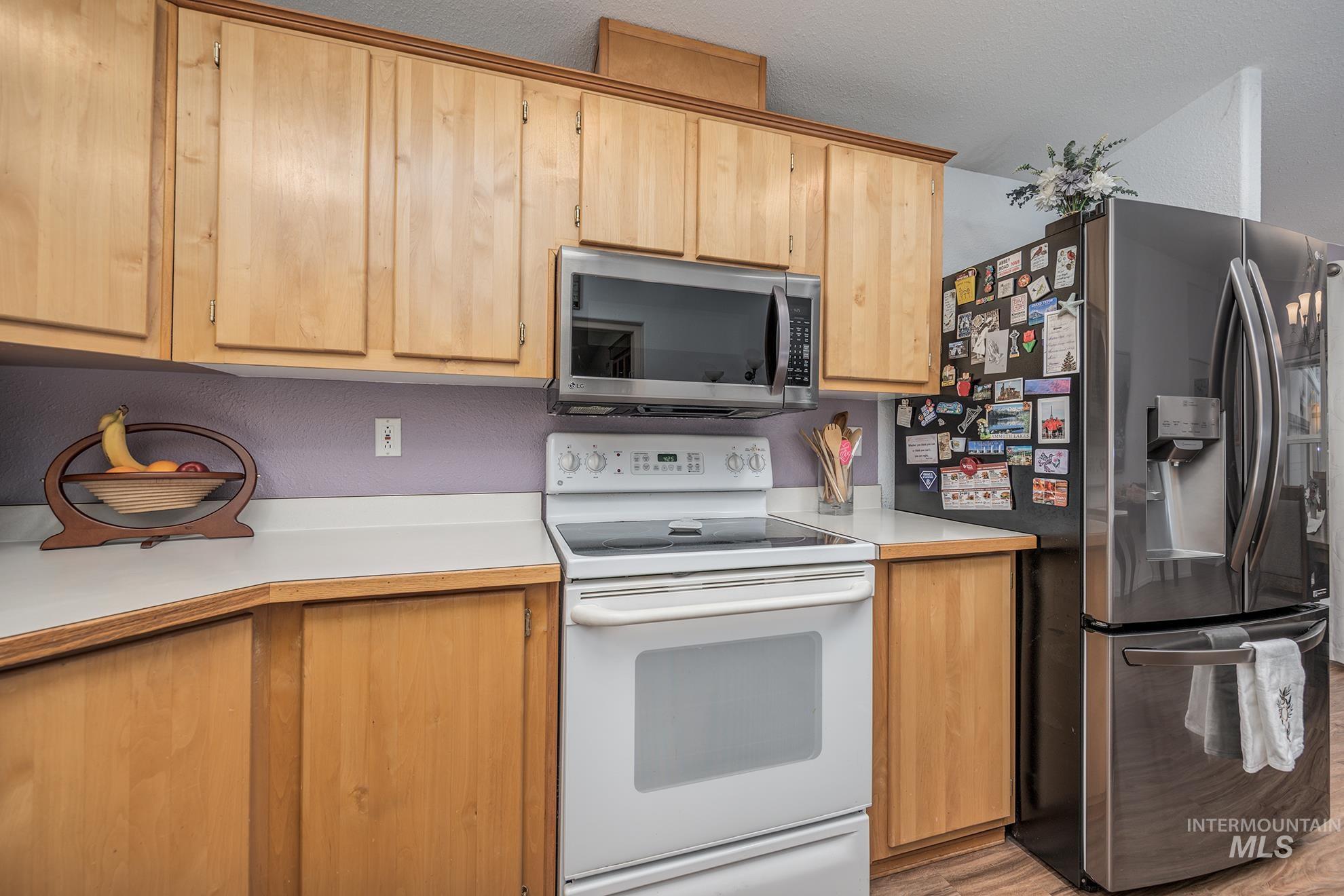 2750 Alden Road, Unit 27 Fruitland, ID 83619 - Photo 15 of 45 Kitchen featuring stainless steel appliances, light countertops, light brown cabinets, and a textured ceiling