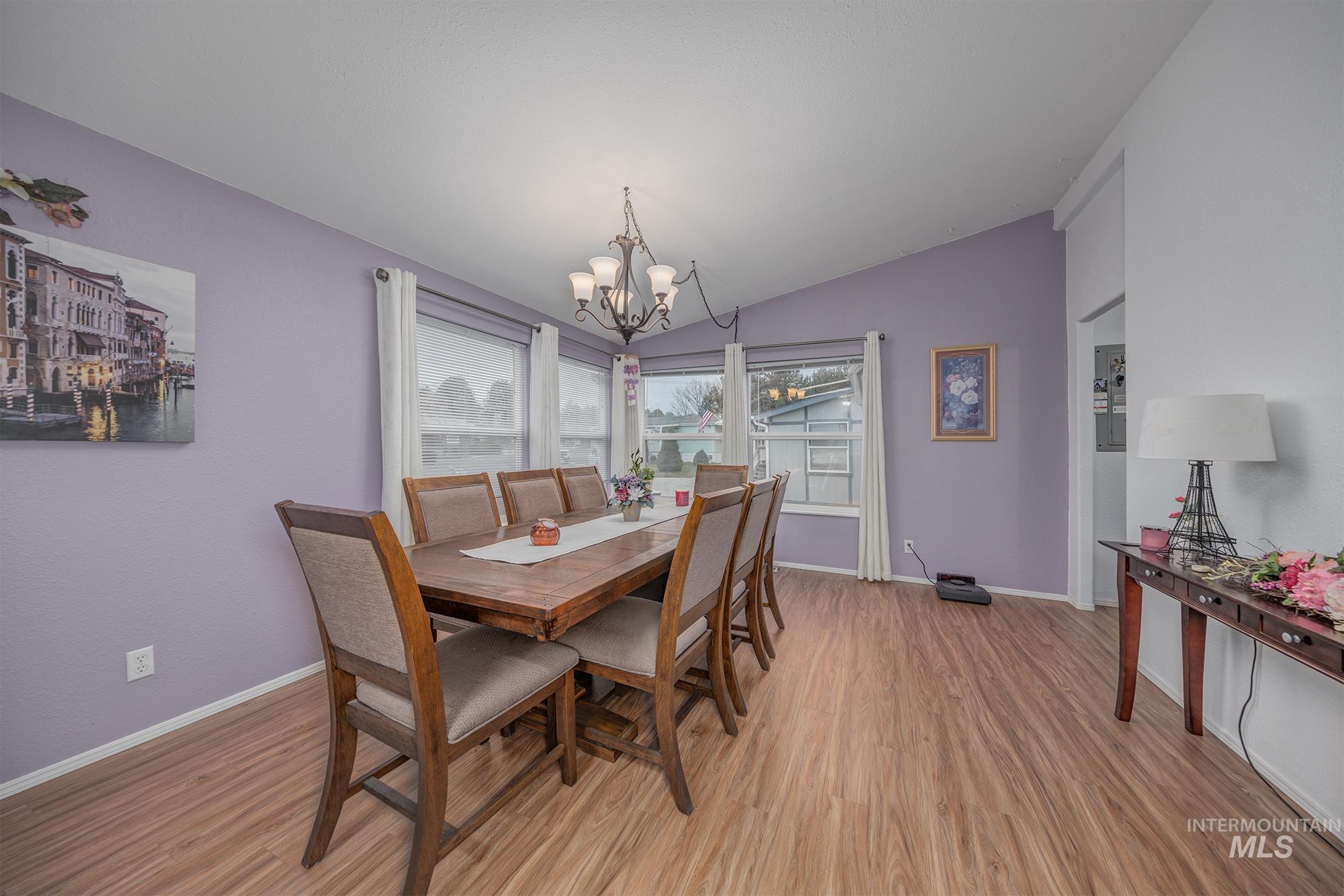 2750 Alden Road, Unit 27 Fruitland, ID 83619 - Photo 17 of 45 Dining space featuring lofted ceiling, light wood-style floors, and a chandelier