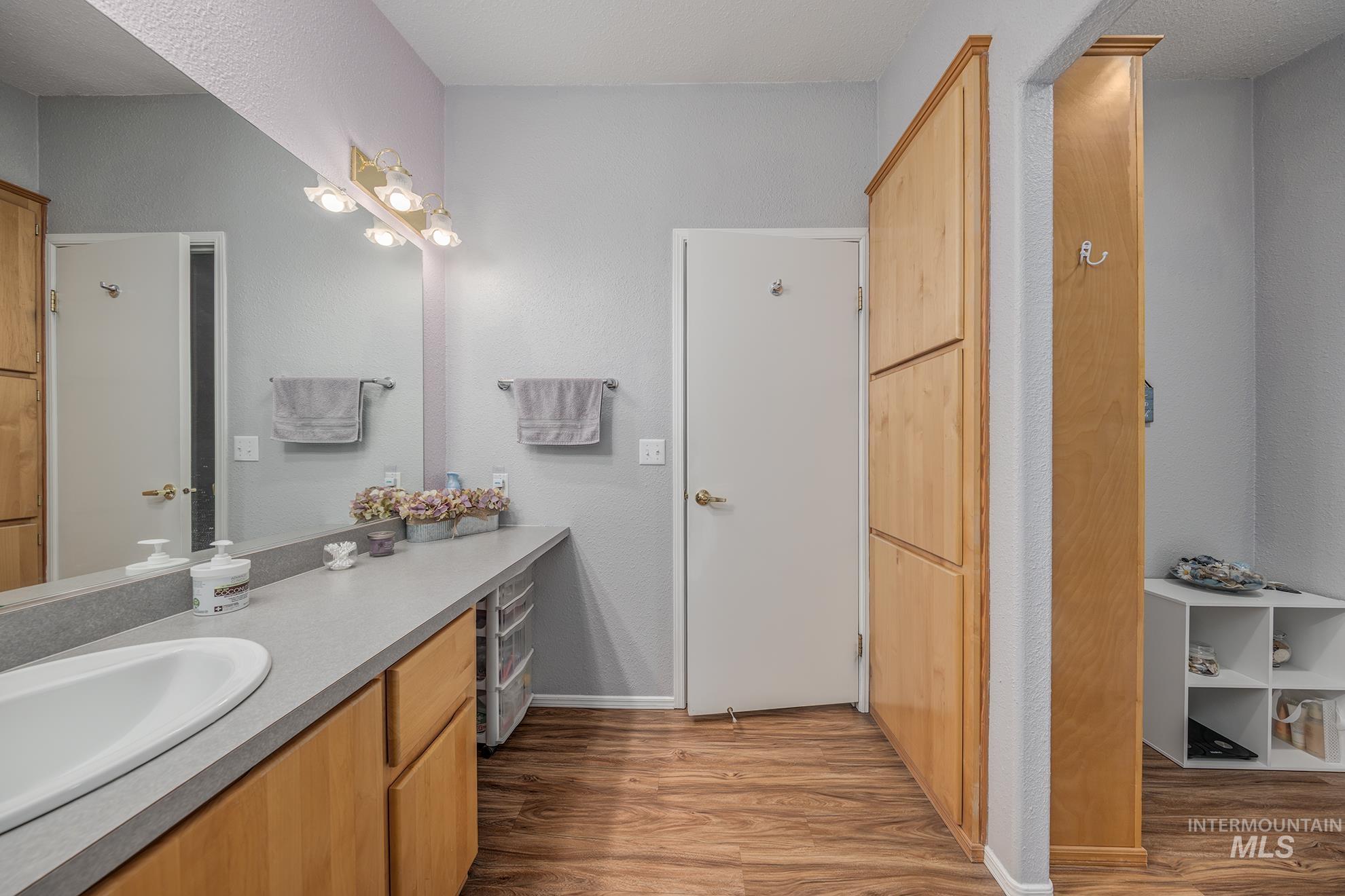 2750 Alden Road, Unit 27 Fruitland, ID 83619 - Photo 20 of 45 Bathroom with vanity, light wood-type flooring, and a textured wall