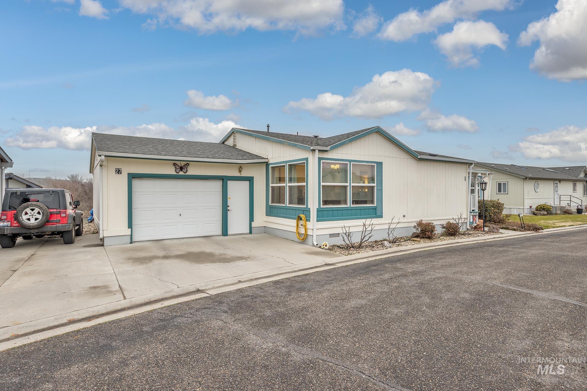 2750 Alden Road, Unit 27 Fruitland, ID 83619 - Photo 3 of 45 View of front of home featuring crawl space, an attached garage, a shingled roof, and driveway