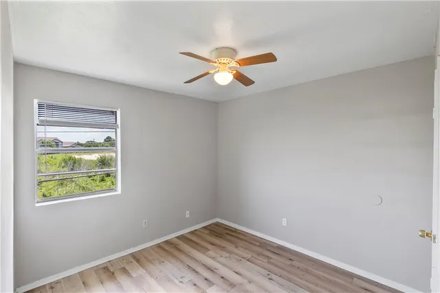 a view of room with window and ceiling fan