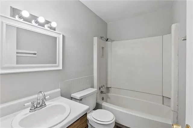 a bathroom with a toilet a sink and a bathtub