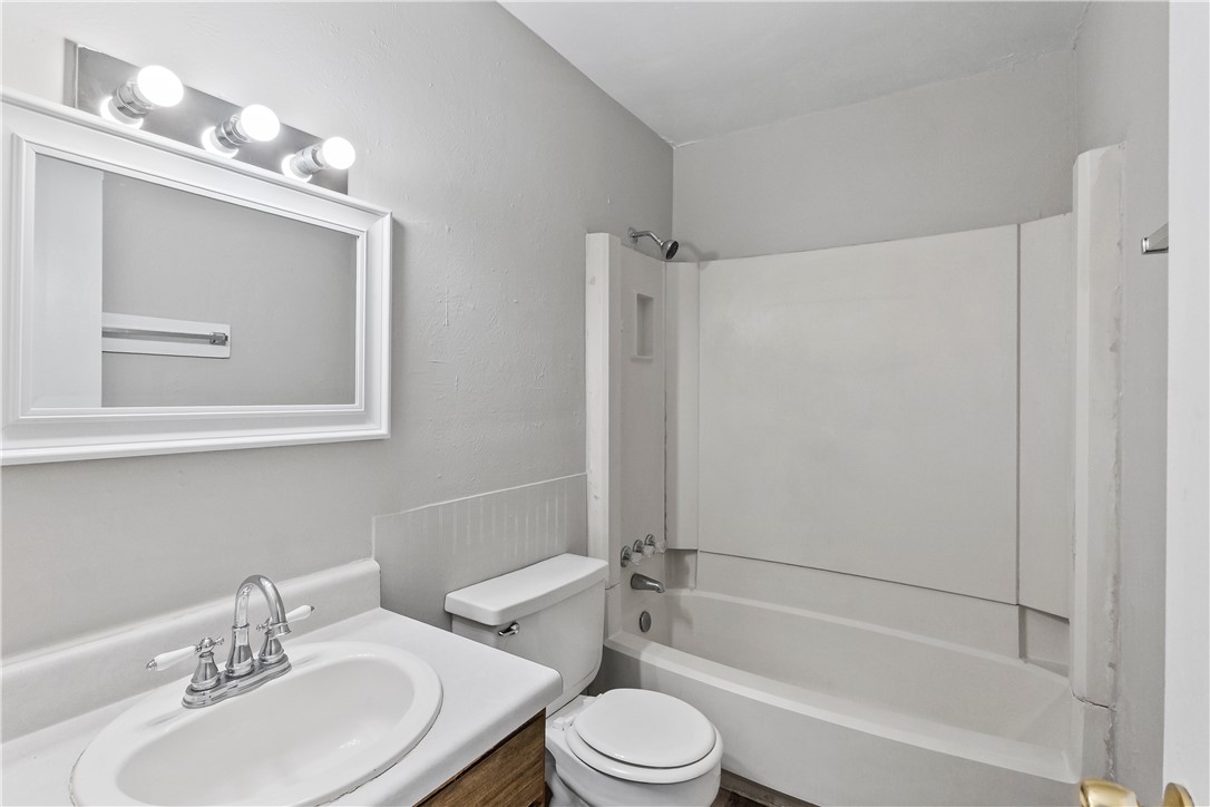 2808 Cypress Bend Circle, Unit A Bryan, TX 77801 - Photo 13 of 15 a bathroom with a toilet a sink and a bathtub