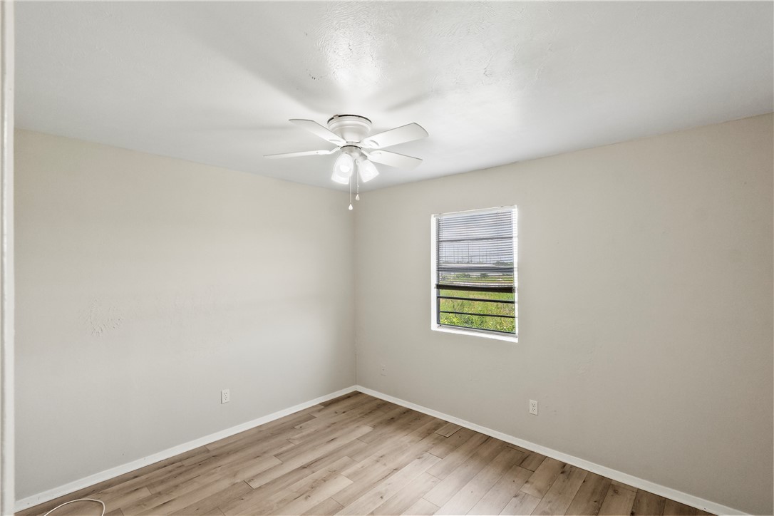 2808 Cypress Bend Circle, Unit A Bryan, TX 77801 - Photo 14 of 15 an empty room with windows and fan