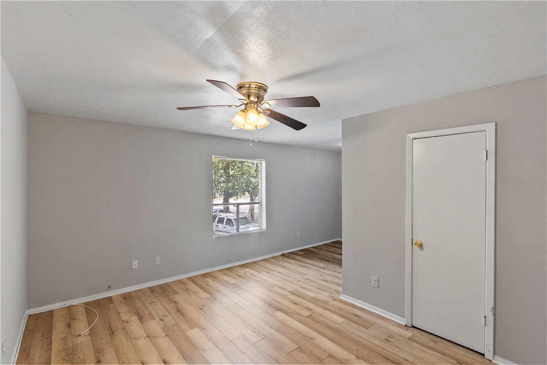 2808 Cypress Bend Circle, Unit A Bryan, TX 77801 - Photo 4 of 15 wooden floor in an empty room with a window