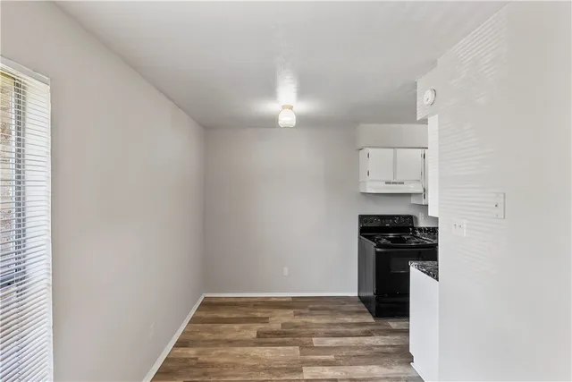 a view of a kitchen with a stove top oven
