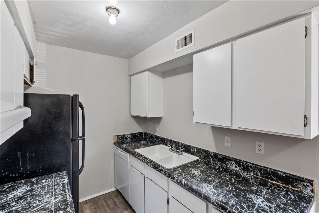 2808 Cypress Bend Circle, Unit A Bryan, TX 77801 - Photo 10 of 15 a kitchen with a refrigerator and a stove top oven