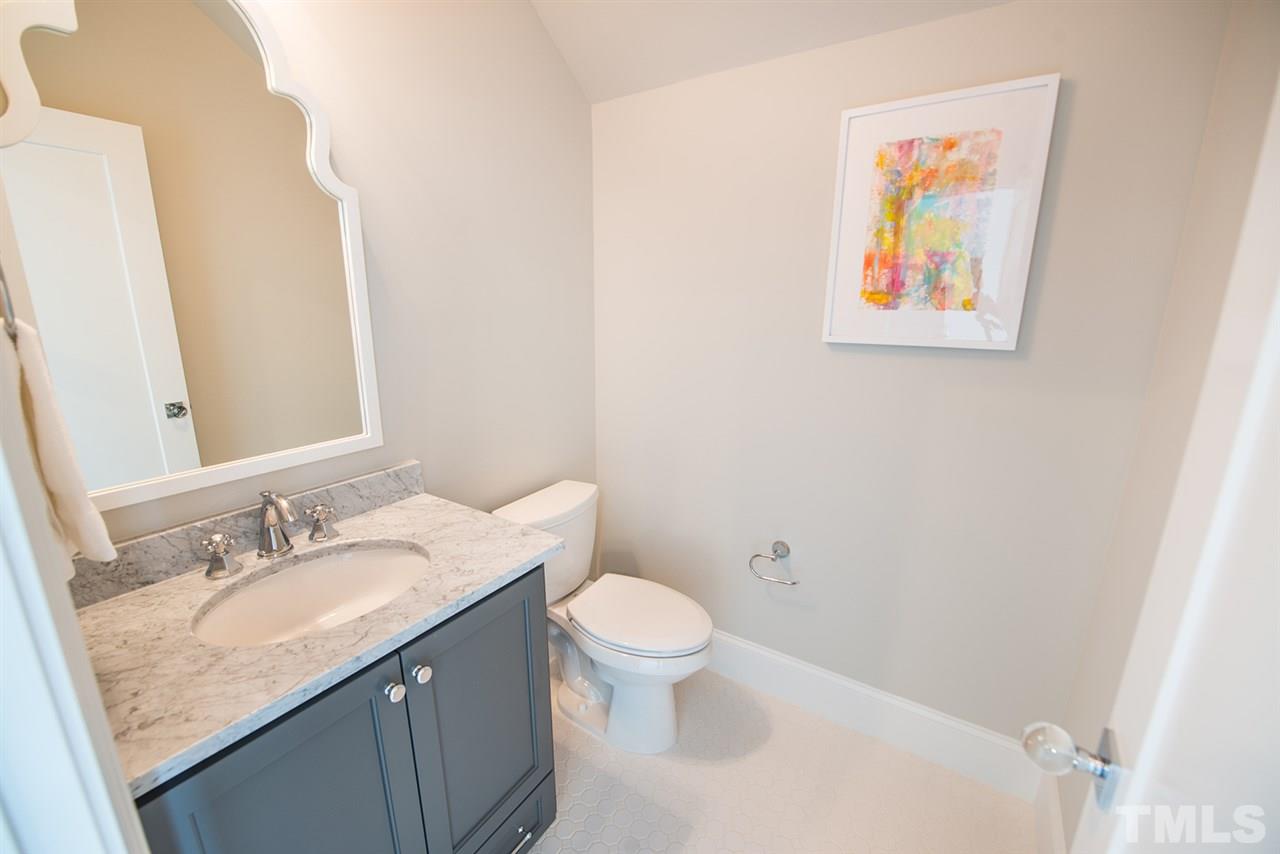 1014 Canterbury Road Raleigh, NC 27607 - Photo 22 of 25 a bathroom with a granite countertop sink mirror vanity and toilet
