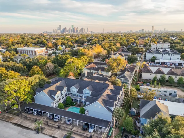 an aerial view of residential houses with city view