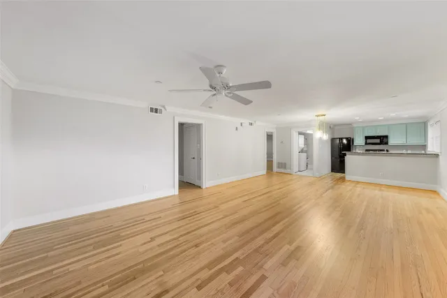 a view of a kitchen with wooden floor and a sink