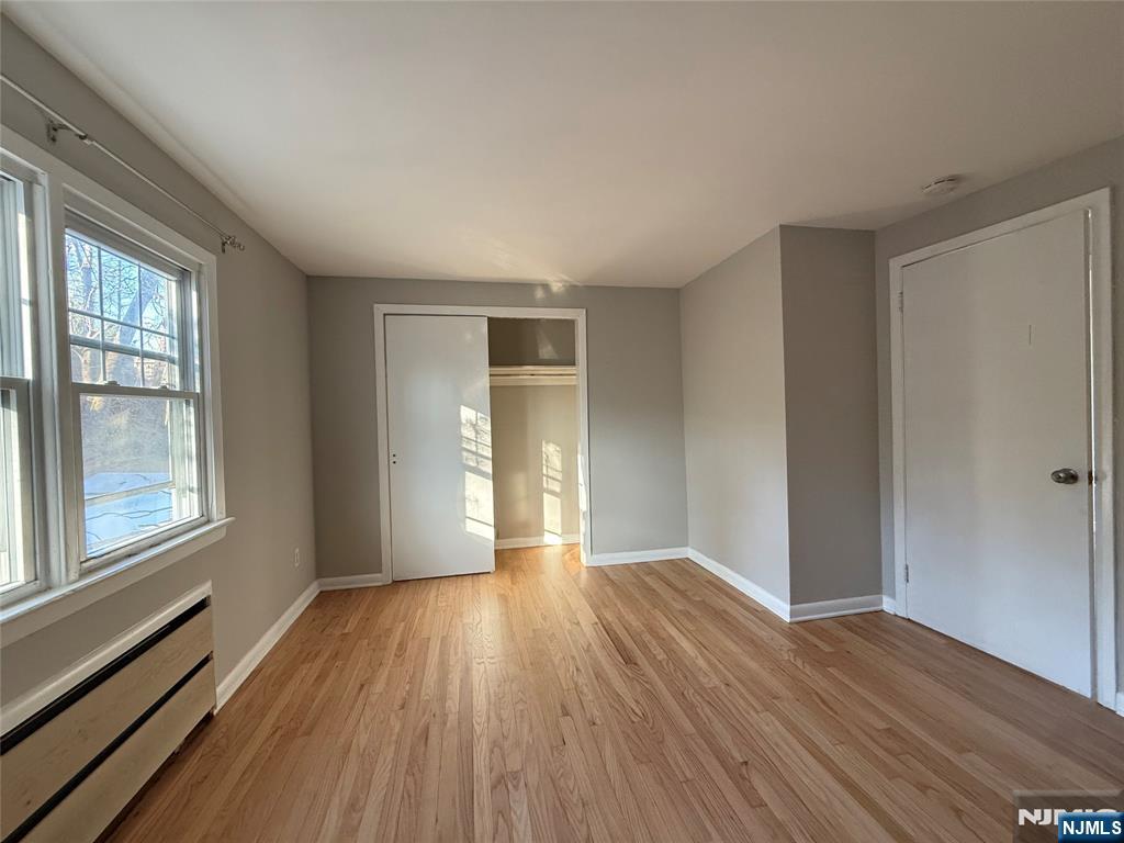175 Van Winkle Street, Unit 2 East Rutherford, NJ 07073 - Photo 15 of 20 a view of an empty room with wooden floor and a window