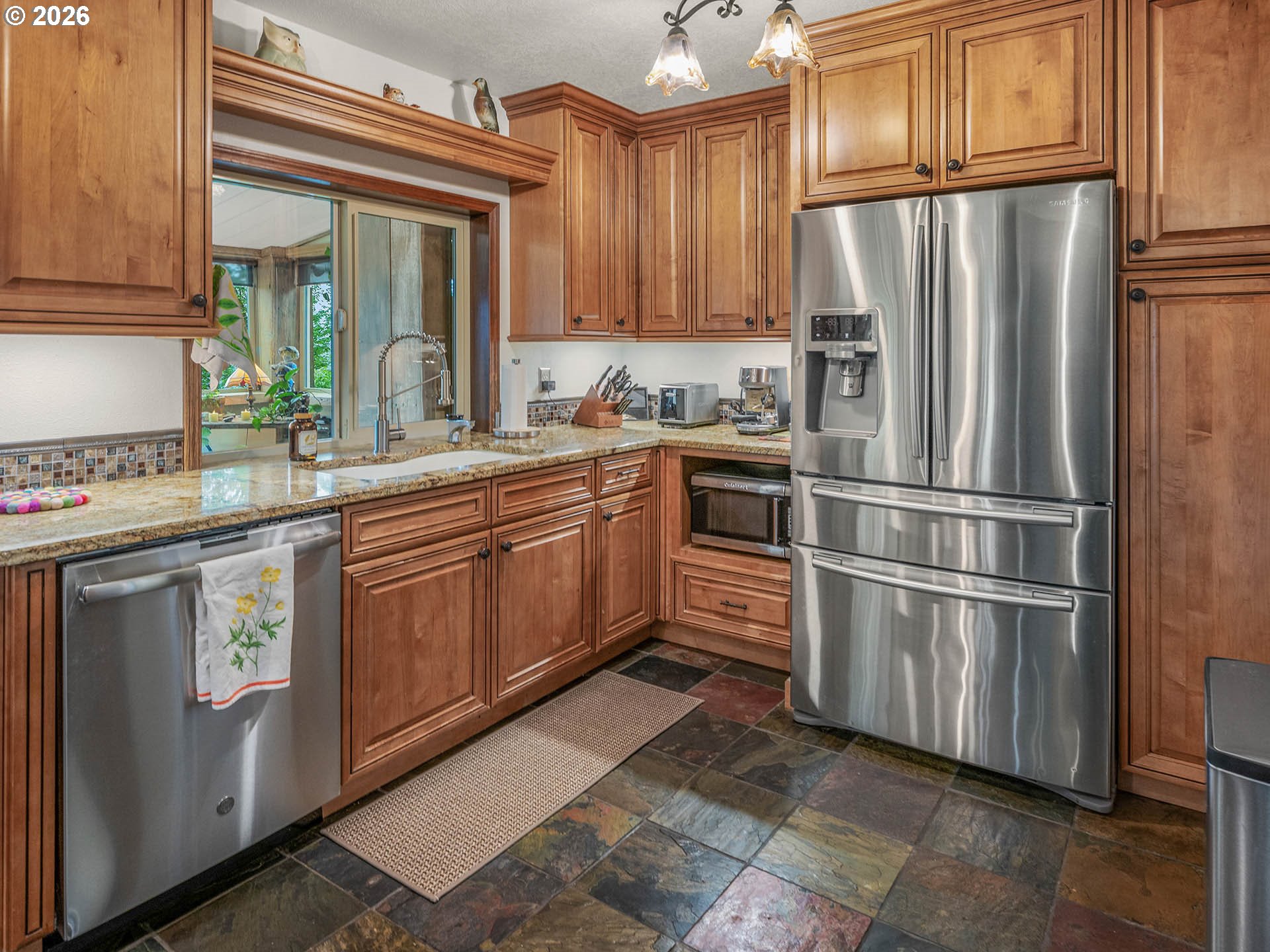 45045 Northwest Elk Mountain Road Banks, OR 97106 - Photo 11 of 48 a kitchen with stainless steel appliances granite countertop a refrigerator sink and cabinets