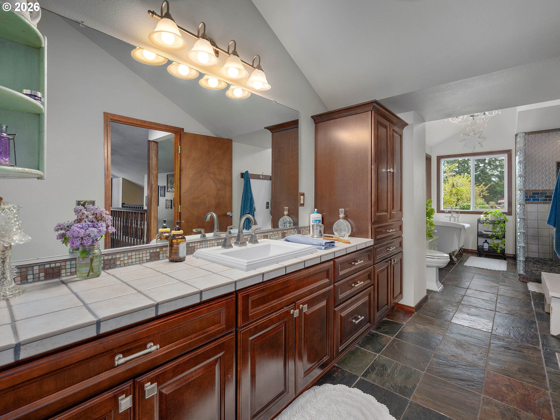 45045 Northwest Elk Mountain Road Banks, OR 97106 - Photo 24 of 48 a spacious bathroom with a granite countertop sink a toilet and a mirror