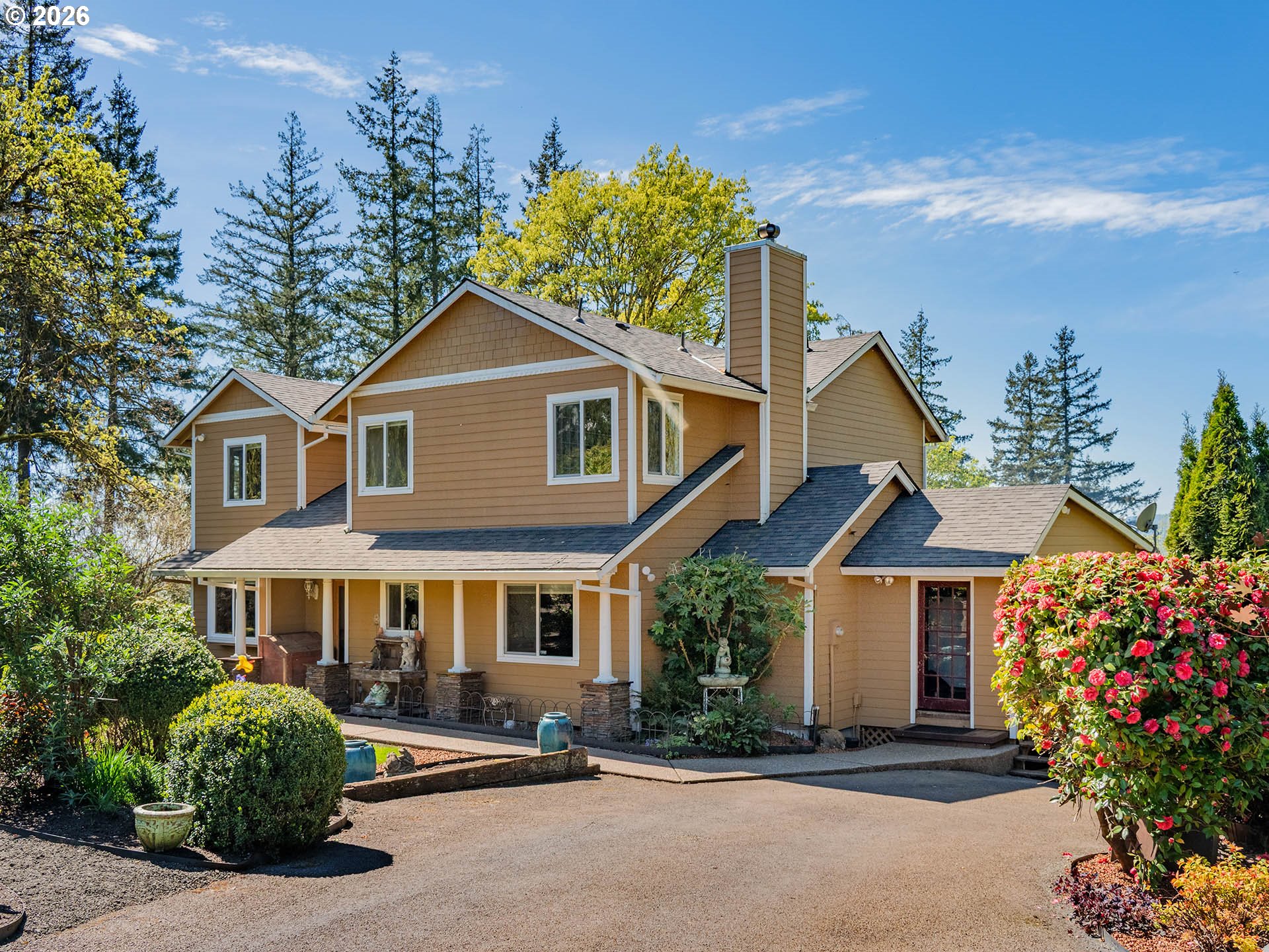 45045 Northwest Elk Mountain Road Banks, OR 97106 - Photo 5 of 48 a front view of a house with a yard and garage