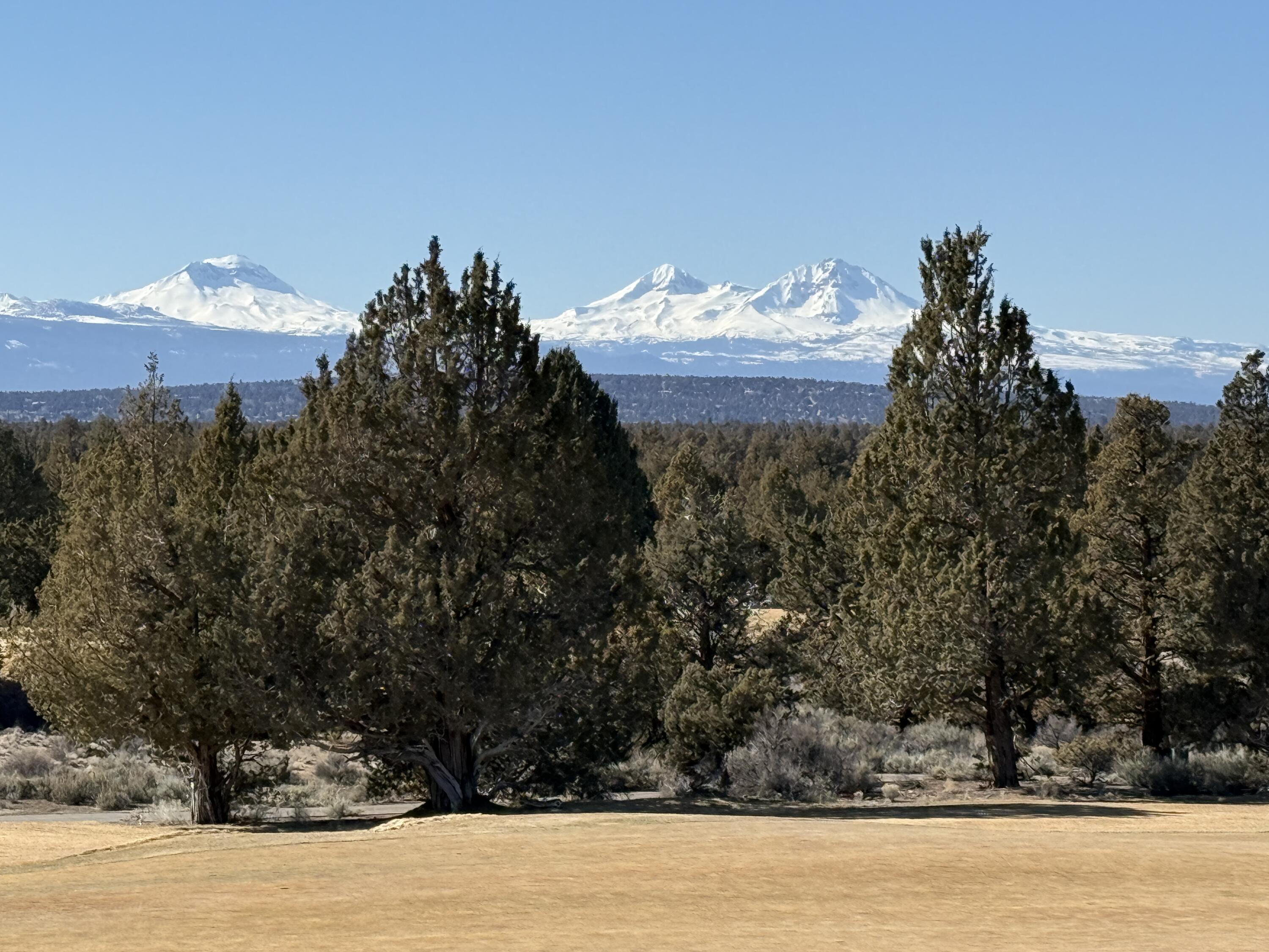 22887 Ghost Tree Lane Bend, OR 97701 - Photo 2 of 97 Breathtaking, unobstructed Cascade Mountain views over the 17th Fazio fairway and dedicated golf cart garage make this a golfer's paradise!