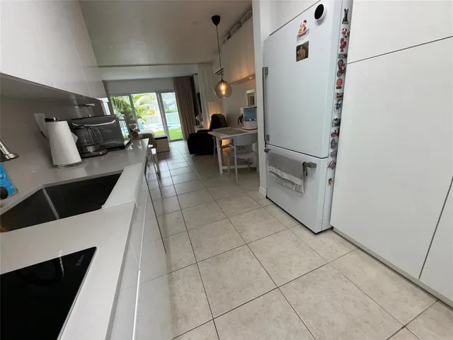 a kitchen with stainless steel appliances granite countertop a sink a stove a microwave and cabinets