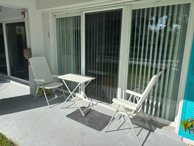 a view of an house with backyard and sitting area