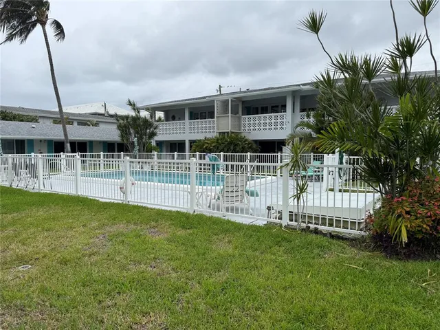 a view of a house with a backyard porch and sitting area