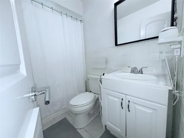 a bed room with a bed and a large window