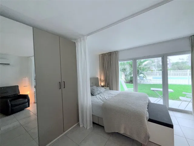 a room with a bed and a large window