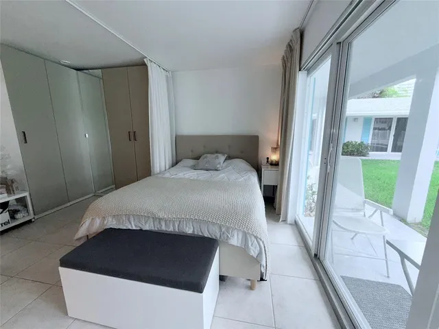 a bedroom with a bed and a mirror