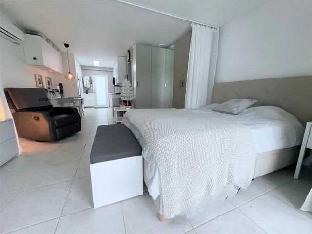a large bedroom with a large bed and a flat screen tv