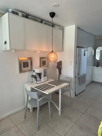 a kitchen with a table and chairs