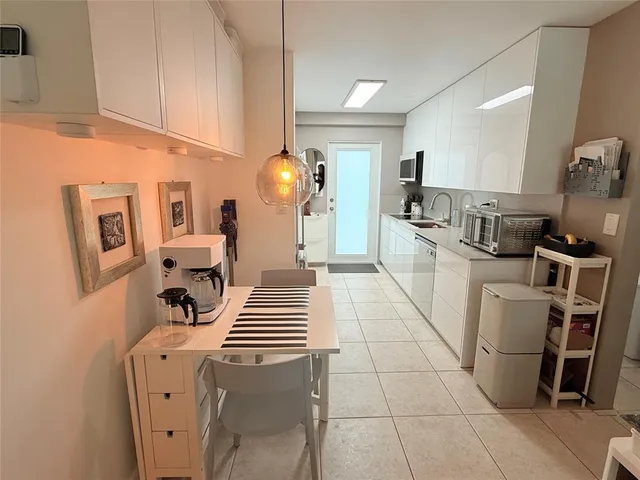 a kitchen with a sink and a stove top oven